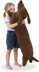 picture of a young girl holding large stuffed dachshund