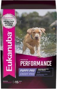 Black bag with pink accents and white writing stating Eukanuba performance puppy pro chiot pro. with picture of puppy running through water