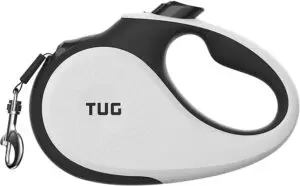 White and black TUG retractable dog leash with ergonomic handle and durable clip for easy, controlled walks.
