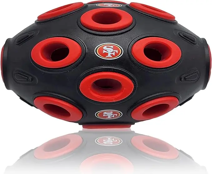 San Francisco 49ers football-shaped dog treat dispensing toy with multiple holes, designed for interactive play and mental stimulation for pets.