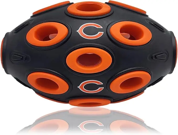 Chicago Bears football-shaped dog treat dispensing toy with multiple holes, designed for interactive play and mental stimulation for pets.