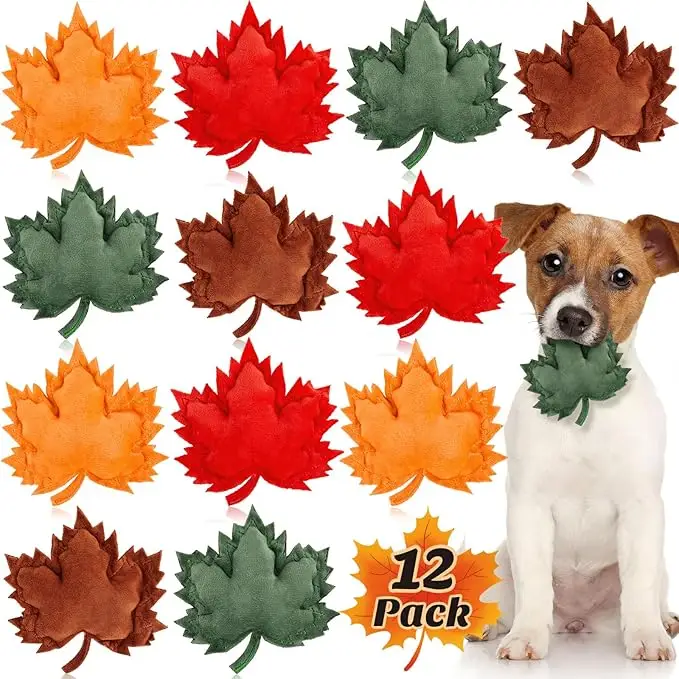 Pack of 12 plush dog toys shaped like colorful fall leaves in orange, red, green, and brown, with a small dog holding one — festive playtime fun in fall essentials for dogs 2025.
