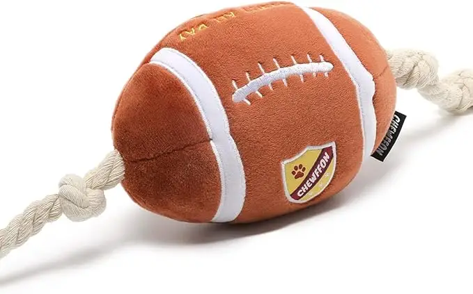 Plush football-shaped dog toy with durable rope ends for tug and fetch play — a fun and sporty pick in fall essentials for dogs 2025.
