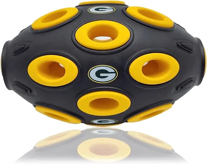 Green Bay Packers football-shaped dog treat dispensing toy with multiple holes, designed for interactive play and mental stimulation for pets.