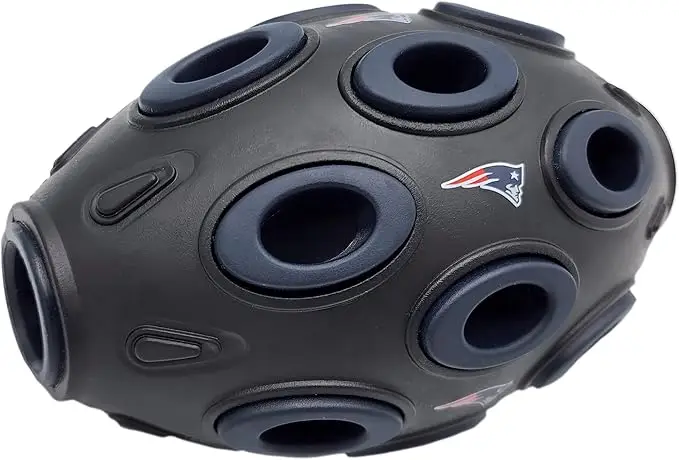 New England Patriots football-shaped dog treat dispensing toy with multiple holes, designed for interactive play and mental stimulation for pets.