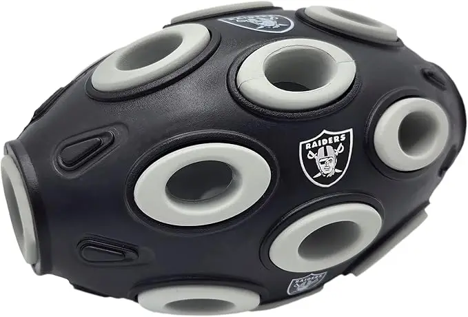 Vegas Raiders football-shaped dog treat dispensing toy with multiple holes, designed for interactive play and mental stimulation for pets.